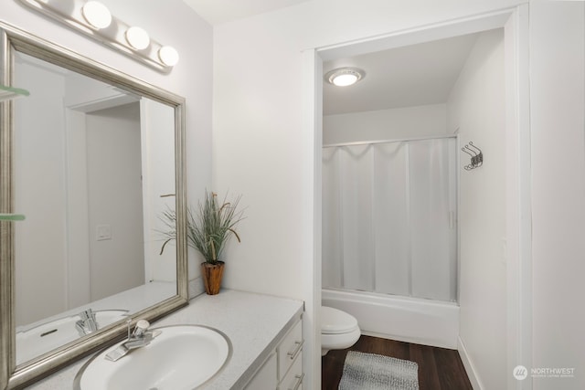 full bathroom featuring toilet, vanity, hardwood / wood-style flooring, and shower / tub combo with curtain