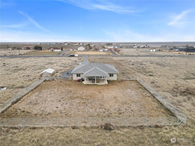 birds eye view of property with a rural view