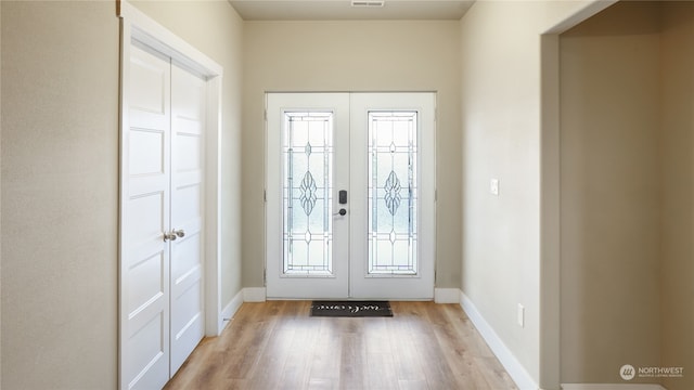 entrance foyer featuring french doors and light hardwood / wood-style flooring