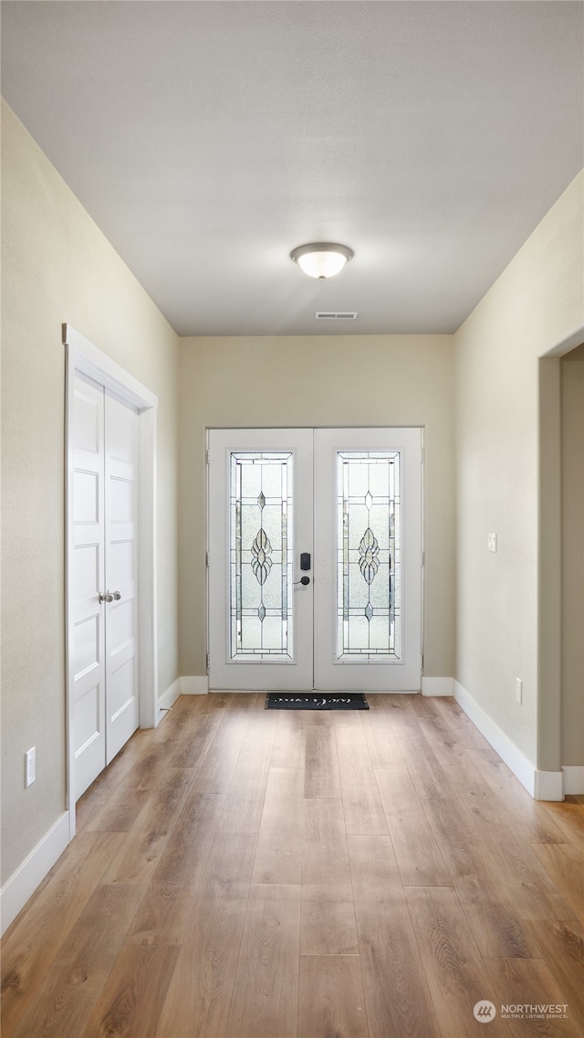 entrance foyer featuring french doors and light wood-type flooring