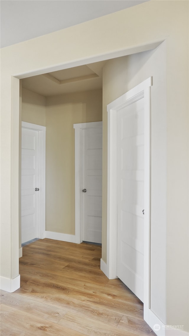 corridor with light wood-type flooring