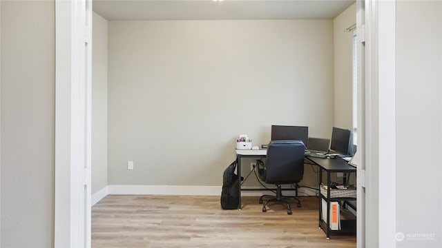 office with light wood-type flooring