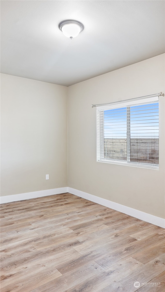 empty room with light hardwood / wood-style floors