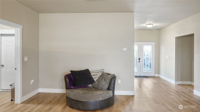 foyer entrance featuring french doors and light wood-type flooring