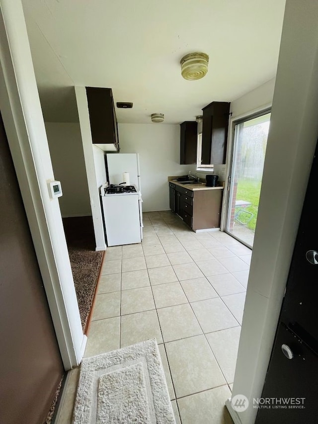 kitchen featuring sink and light tile flooring