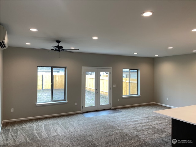 spare room featuring french doors, ceiling fan, and carpet