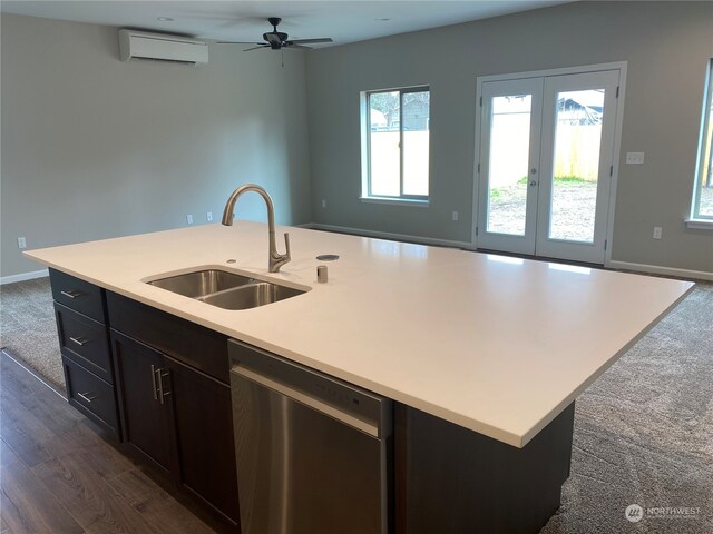 kitchen featuring ceiling fan, dishwasher, dark hardwood / wood-style flooring, sink, and a kitchen island with sink