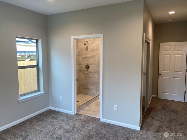 unfurnished bedroom featuring dark colored carpet