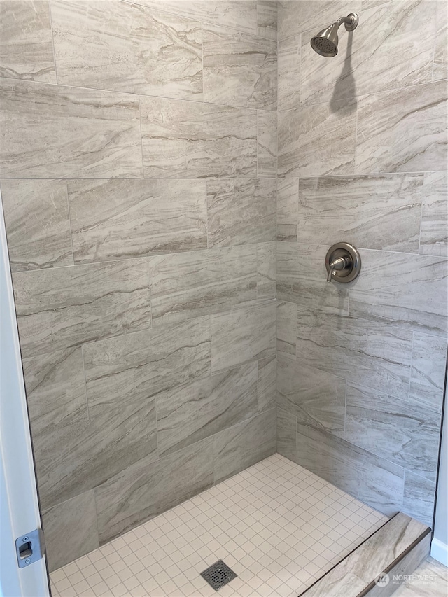 bathroom with a tile shower