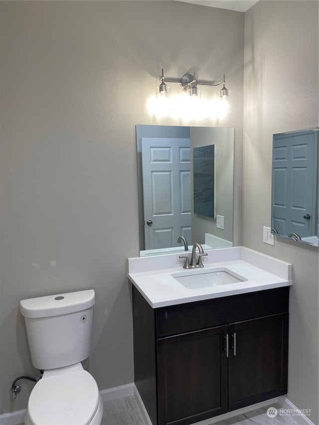 bathroom with toilet, tile floors, and oversized vanity