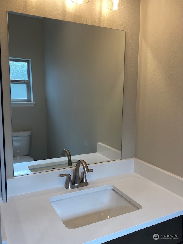 bathroom featuring toilet and vanity