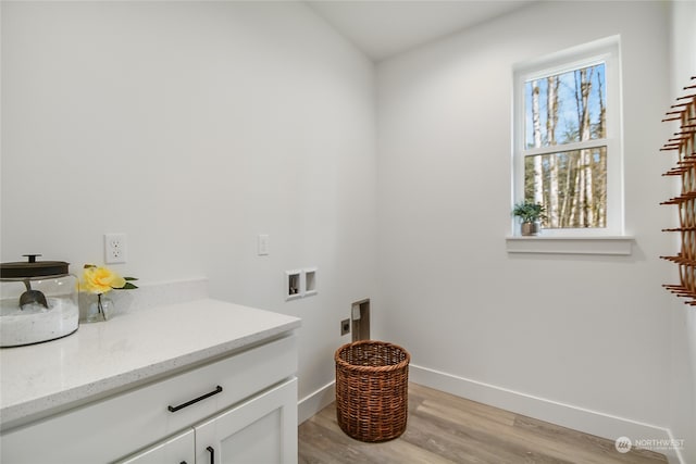 washroom featuring cabinets, hookup for a washing machine, light wood-type flooring, and electric dryer hookup