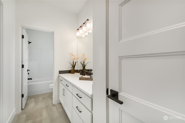 full bathroom featuring vanity, toilet, shower / tub combination, and wood-type flooring