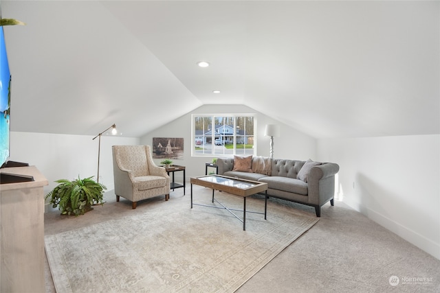 carpeted living room featuring lofted ceiling