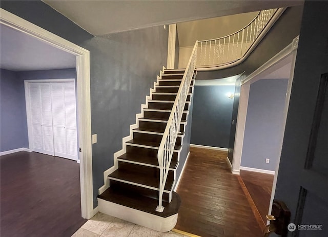 stairs featuring hardwood / wood-style floors