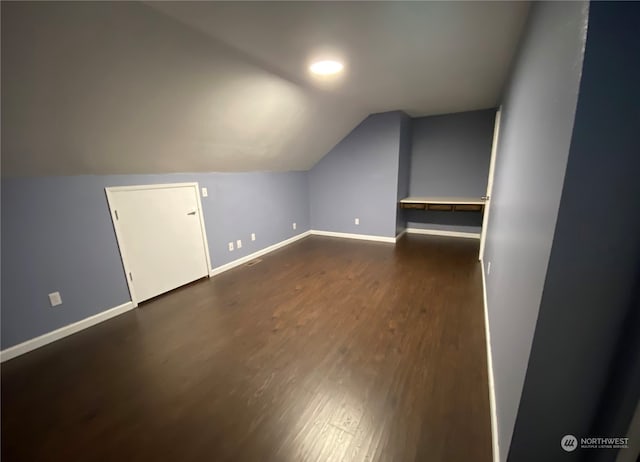 bonus room featuring lofted ceiling and dark wood-type flooring