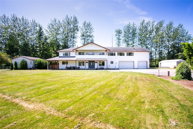 view of front of property with a front lawn, an outdoor structure, and a garage