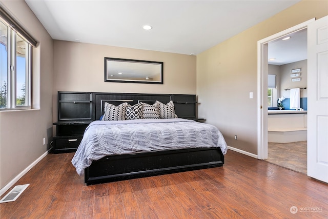 bedroom featuring multiple windows and dark wood-type flooring