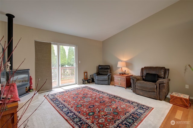 living room featuring a wood stove and light wood-type flooring