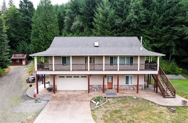 view of front facade with central AC, a balcony, and a garage