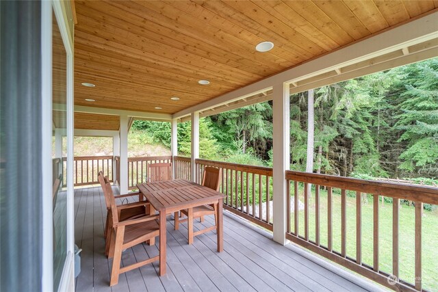 wooden terrace with a lawn