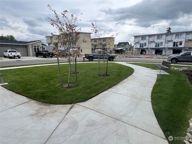 view of community with a yard and a residential view