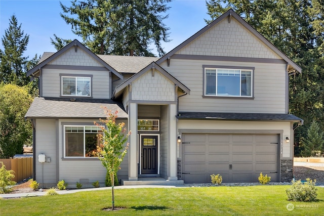 craftsman-style home featuring a front yard and a garage