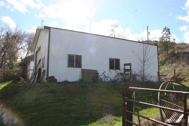 view of side of home with a lawn