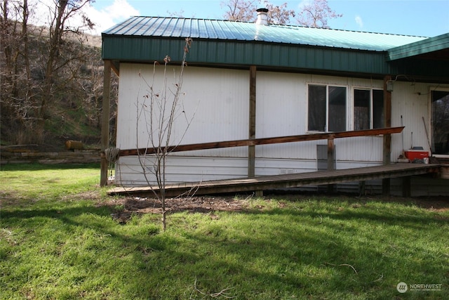 view of side of home with a yard