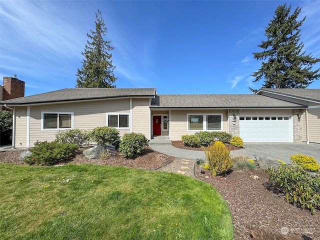 ranch-style home with a garage and a front lawn