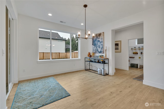 dining room with a chandelier and hardwood / wood-style floors