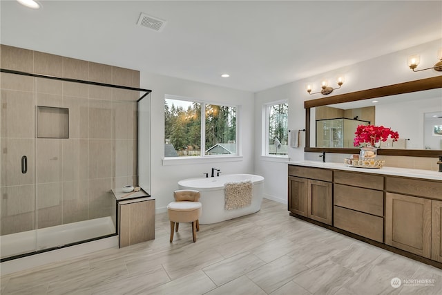 bathroom with vanity and plus walk in shower