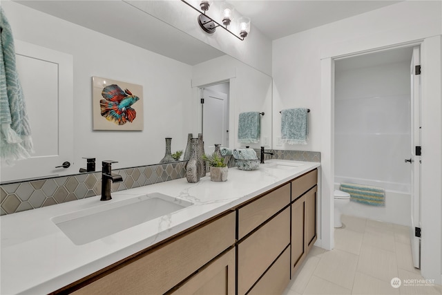 bathroom with tile patterned flooring, vanity, and toilet