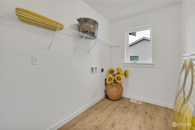 laundry room with hardwood / wood-style floors, hookup for a washing machine, and electric dryer hookup