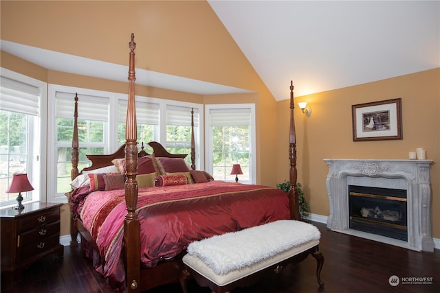 bedroom with high vaulted ceiling, multiple windows, and dark hardwood / wood-style flooring