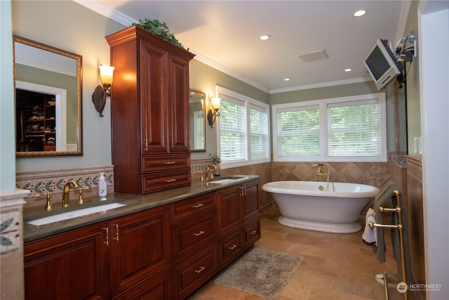 bathroom with tile flooring, crown molding, dual bowl vanity, and tile walls