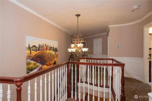 corridor with a chandelier, dark colored carpet, and crown molding