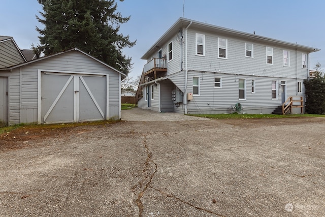 rear view of house with an outdoor structure