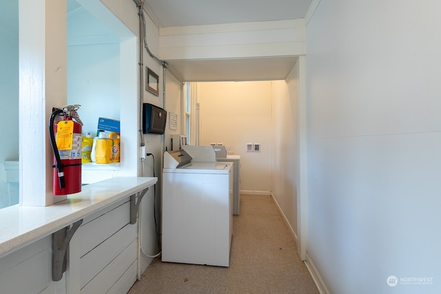 washroom with light carpet and washer and dryer