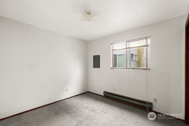 carpeted empty room featuring a baseboard radiator