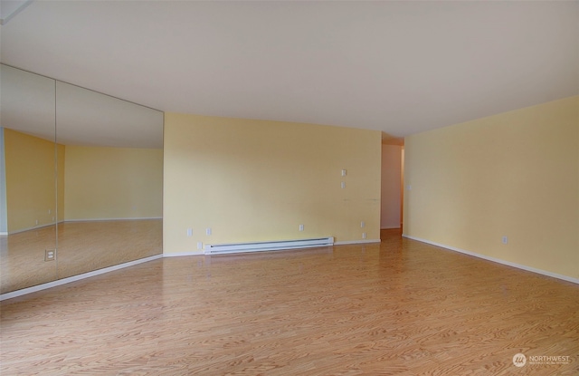 spare room featuring light hardwood / wood-style floors and baseboard heating