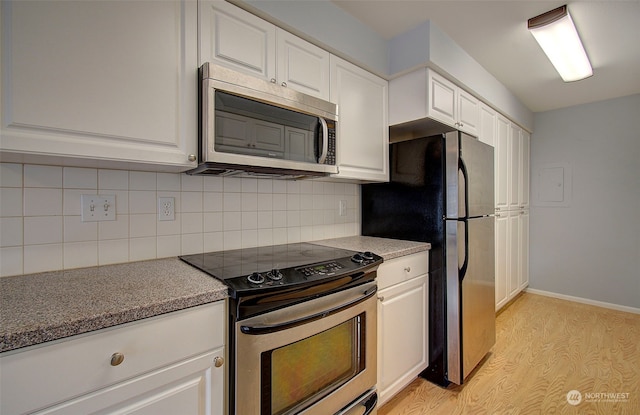 kitchen featuring white cabinets, stainless steel appliances, and light hardwood / wood-style flooring