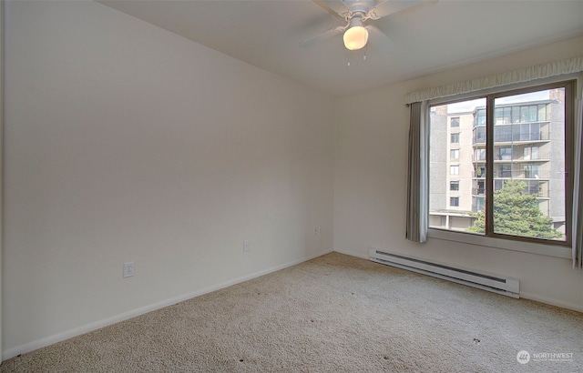 carpeted empty room featuring ceiling fan, a wealth of natural light, and a baseboard radiator