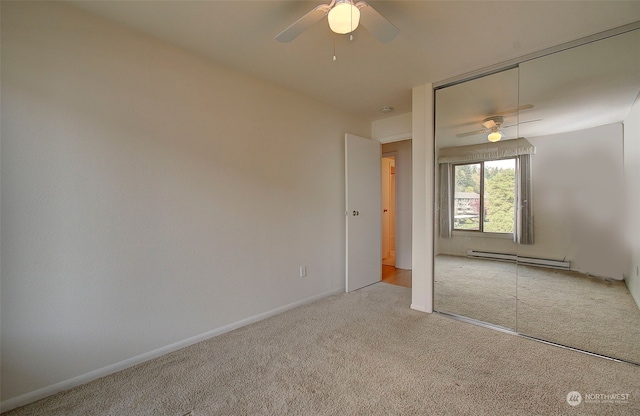 unfurnished bedroom with light carpet, ceiling fan, a baseboard radiator, and a closet