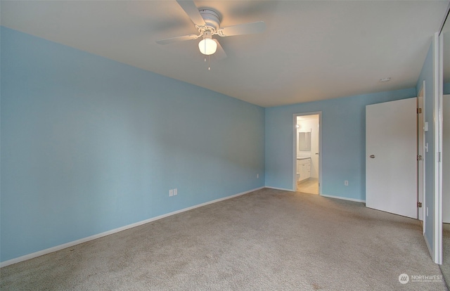 unfurnished bedroom featuring light carpet, ceiling fan, and connected bathroom