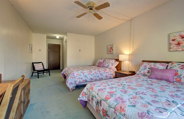 bedroom featuring light carpet, a textured ceiling, and ceiling fan