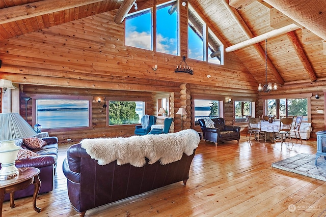 living room featuring beamed ceiling, wood-type flooring, wooden ceiling, and an inviting chandelier