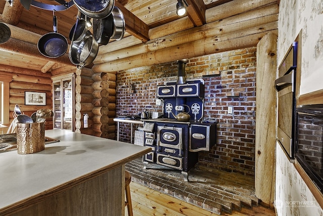 interior space with beam ceiling, log walls, wooden ceiling, and hardwood / wood-style flooring