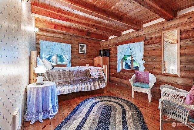 bedroom with hardwood / wood-style flooring, rustic walls, wooden ceiling, and beamed ceiling