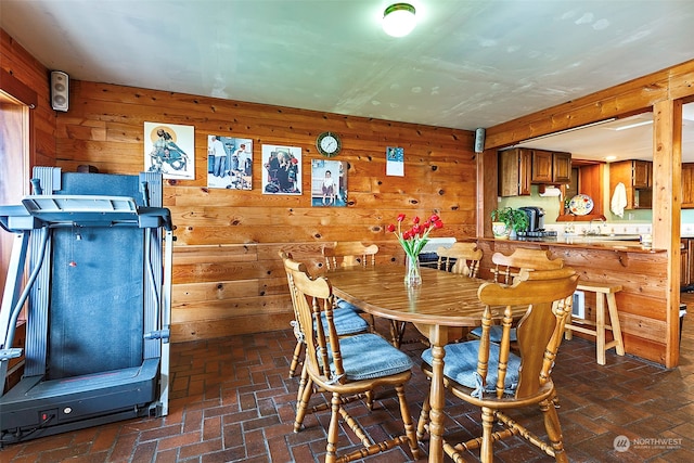 dining room with wood walls